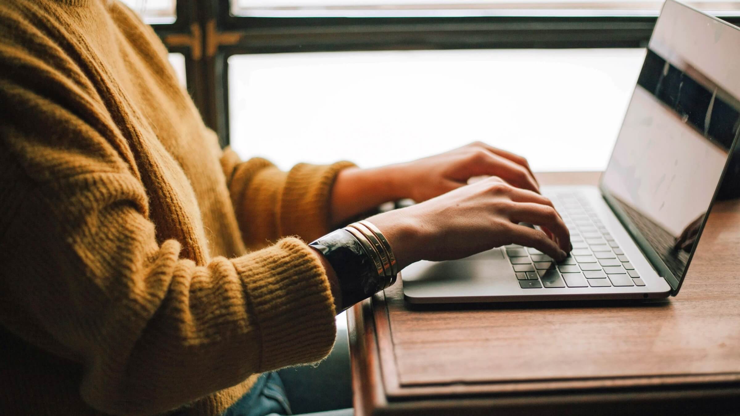 Person typing on a laptop at a desk