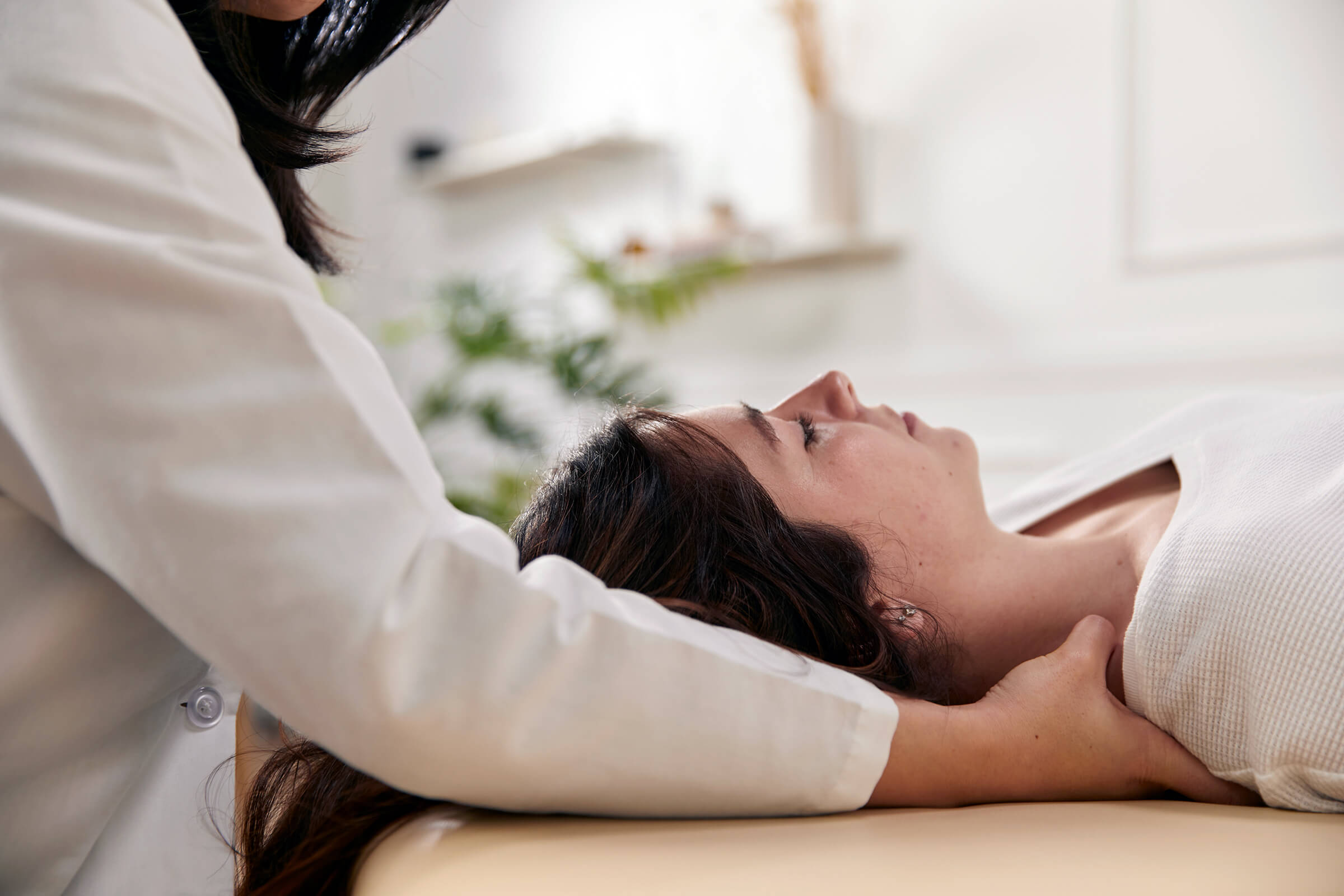 Provider supporting a patient during an integrative hands-on treatment session at the UC San Diego Center for Integrative Medicine.